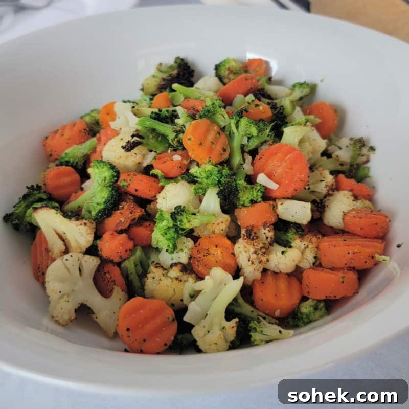 vegetable mix with cauliflower, broccoli and carrots in a white bowl