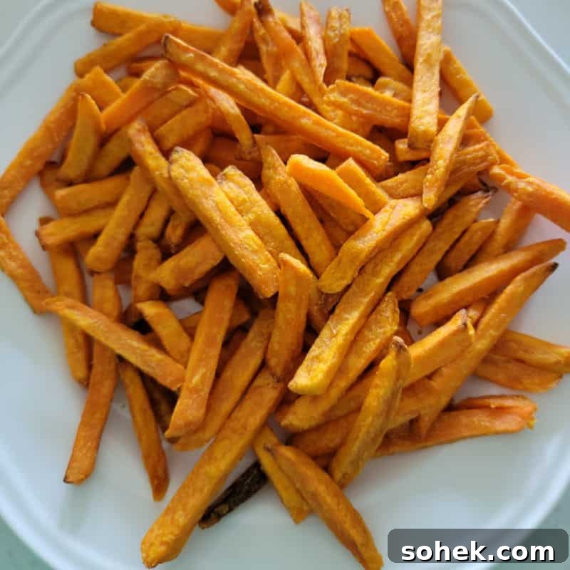 Air fried sweet potato fries on a white plate