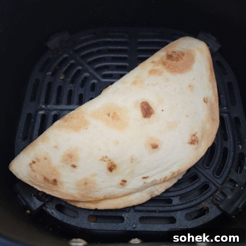 air fried quesadilla in an air fryer basket.