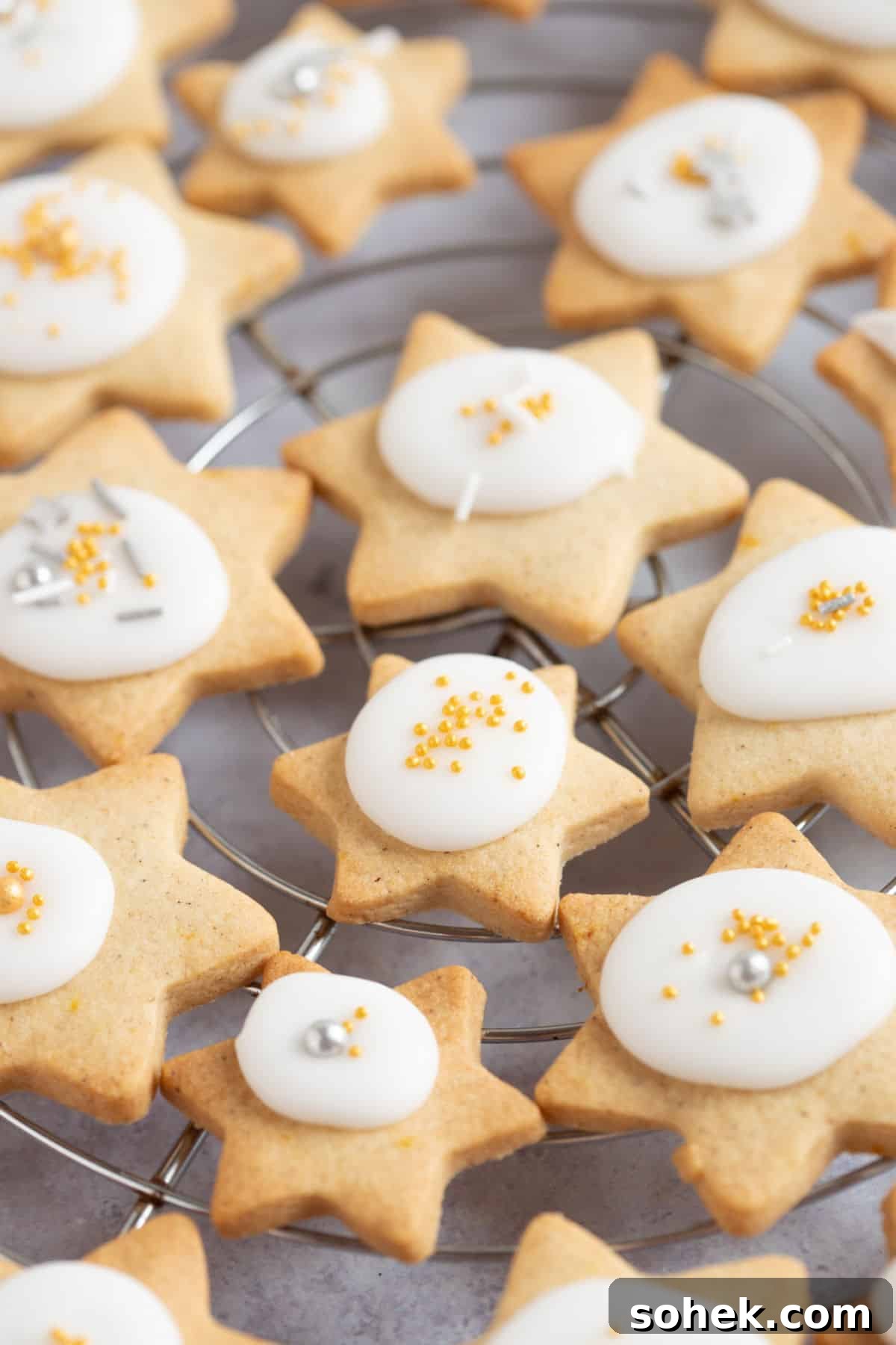 Christmas star biscuits on a wire rack.