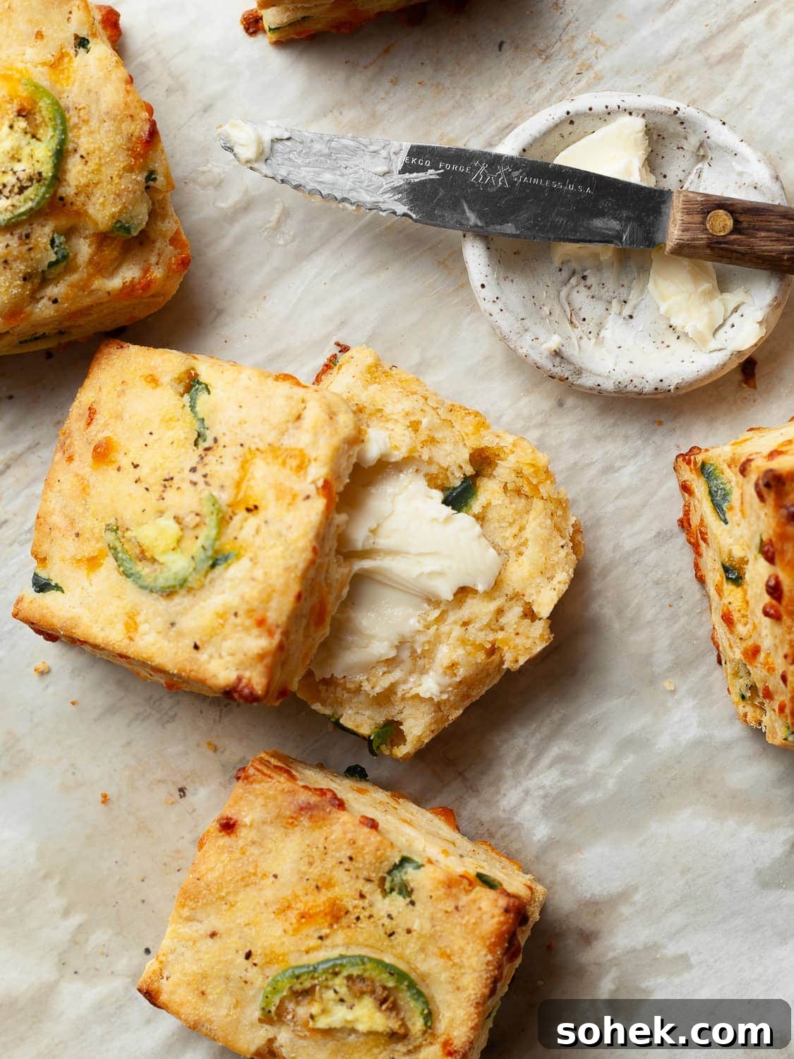 Gluten-Free Jalapeño Cheddar Biscuits Recipe for Crispy Flavor 8 gluten free jalapeno cheddar biscuits sliced in half, topped with butter