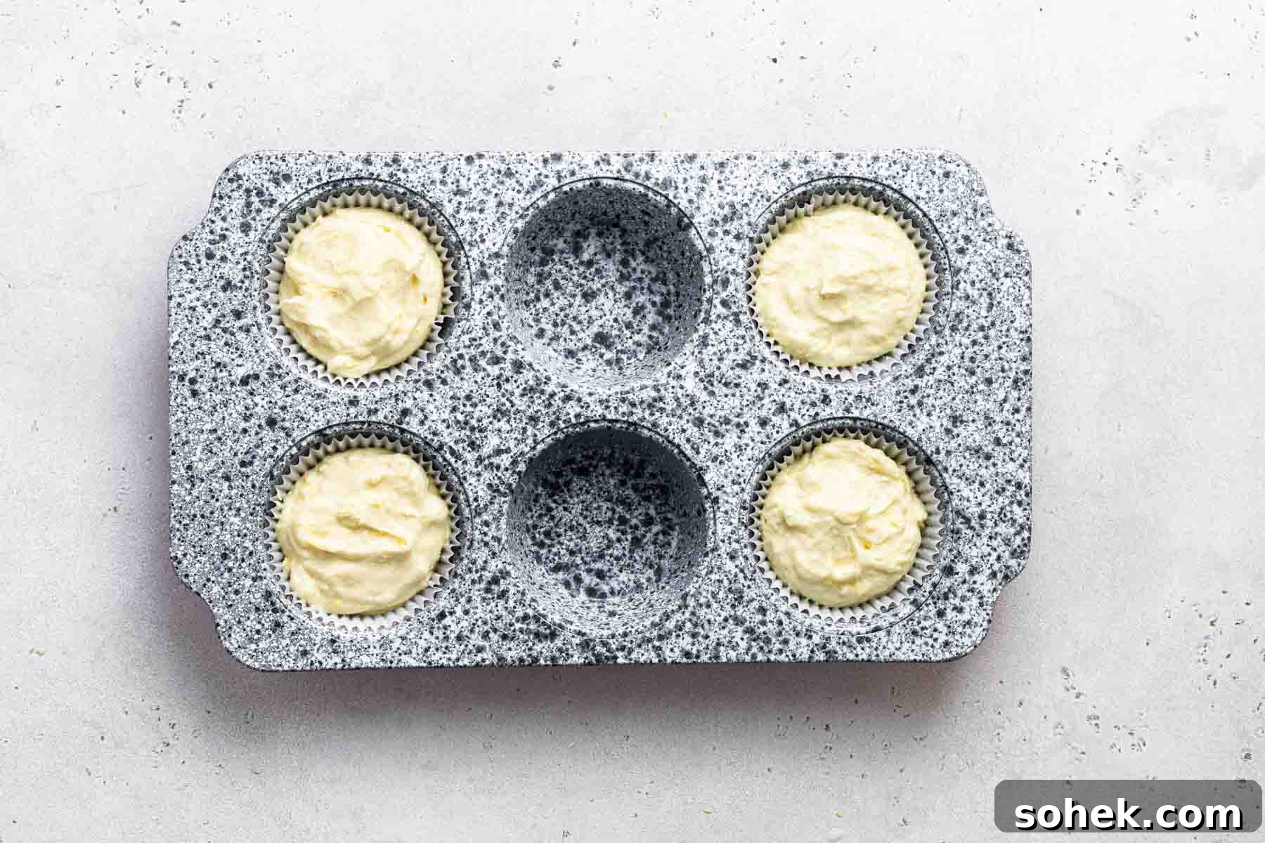 Zesty Lemon Cupcakes Recipe with Luscious Lemon Frosting 9 Raw lemon cupcake batter in muffin pan, before baking.