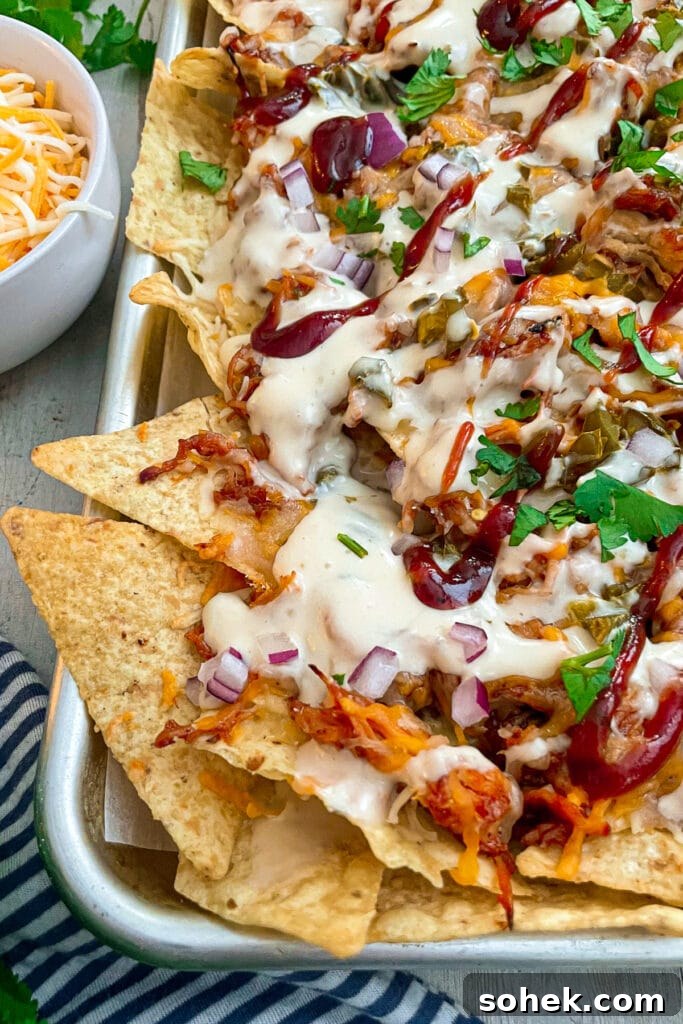 Sheet Pan BBQ Chicken Nachos for Crowd-Friendly Game Night 3 close up shot of sheet pan BBQ chicken nachos