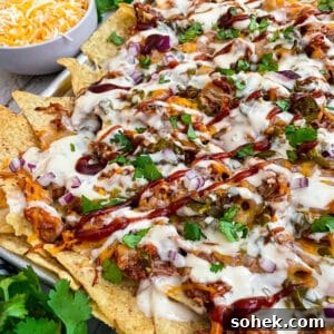Sheet Pan BBQ Chicken Nachos for Crowd-Friendly Game Night 5 close up shot of BBQ chicken nachos baked on a sheet pan