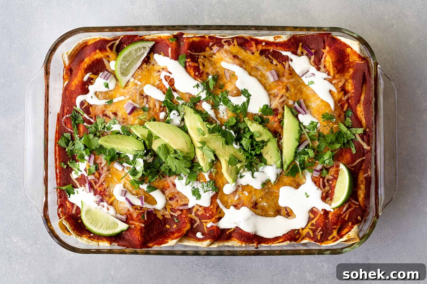 Sweet Potato Enchilada Casserole Recipe — Layered Comfort Bake 4 A sweet potato enchiladas topped with avocado and cilantro.