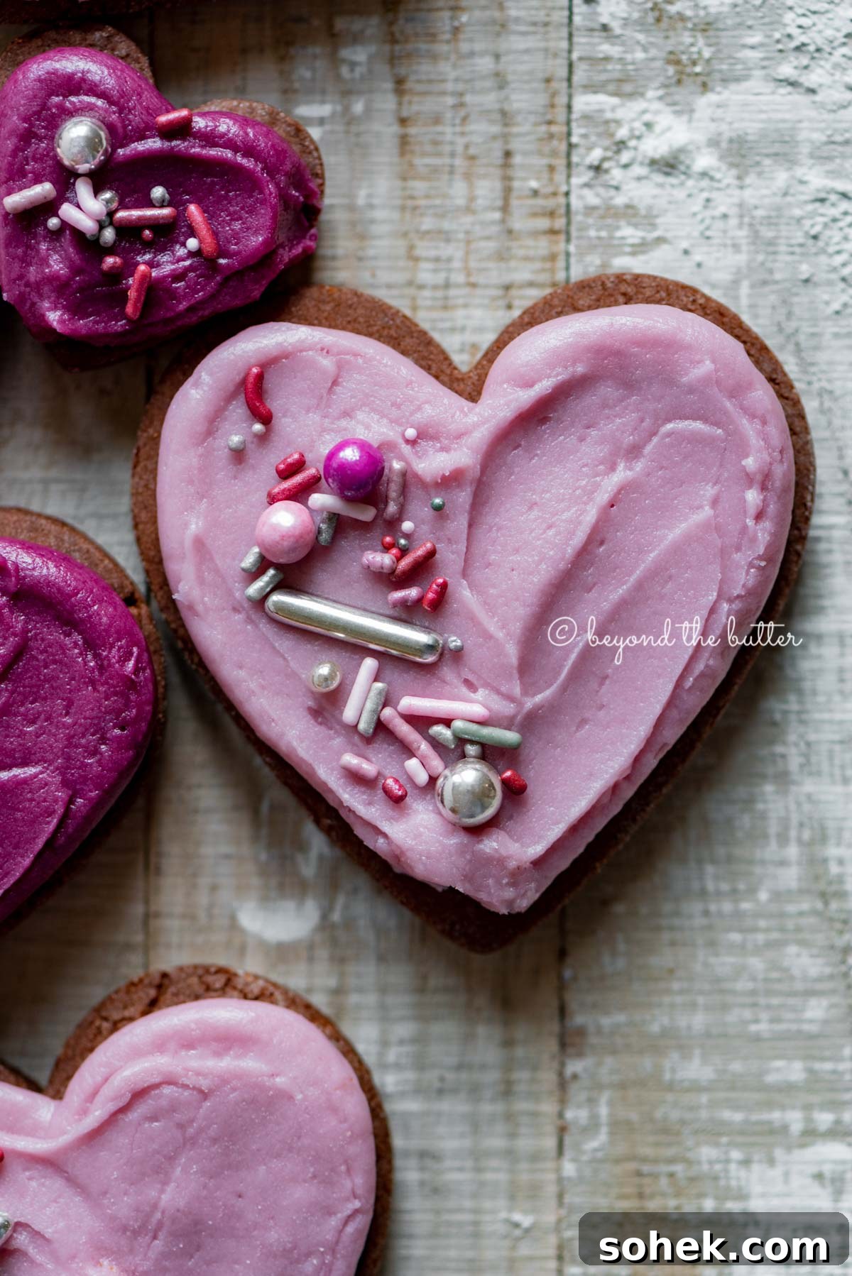 Chocolate Cut-Out Cookies: Decadent Cocoa Sugar Cookies for Decorating 4 Closeup of decorated chocolate cut out sugar cookies on a light wood colored background | All Images © Beyond the Butter®