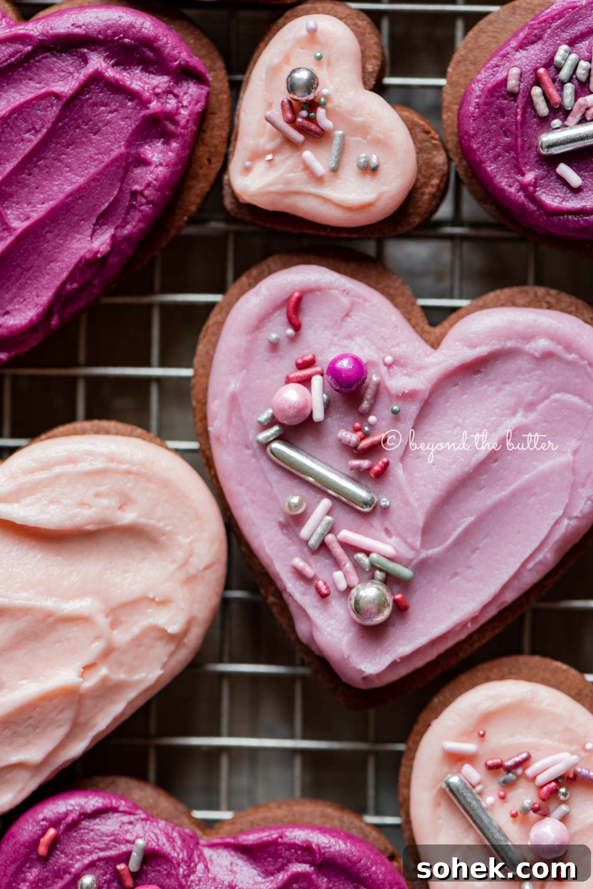Chocolate Cut-Out Cookies: Decadent Cocoa Sugar Cookies for Decorating 6 Closeup of decorated chocolate cut out sugar cookies on a wire cooling rack on light wood colored background | All Images © Beyond the Butter®