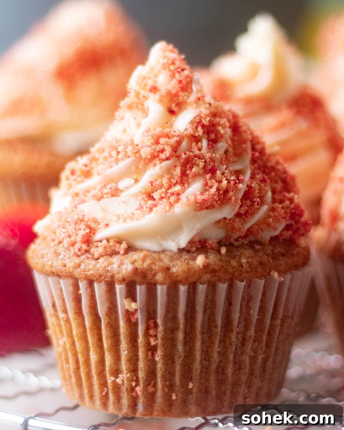 Strawberry Crunch Cupcakes Recipe with Crispy Topping 6 A vibrant array of strawberry crunch cupcakes, each with a creamy top and strawberry crumble, promising a burst of flavor.