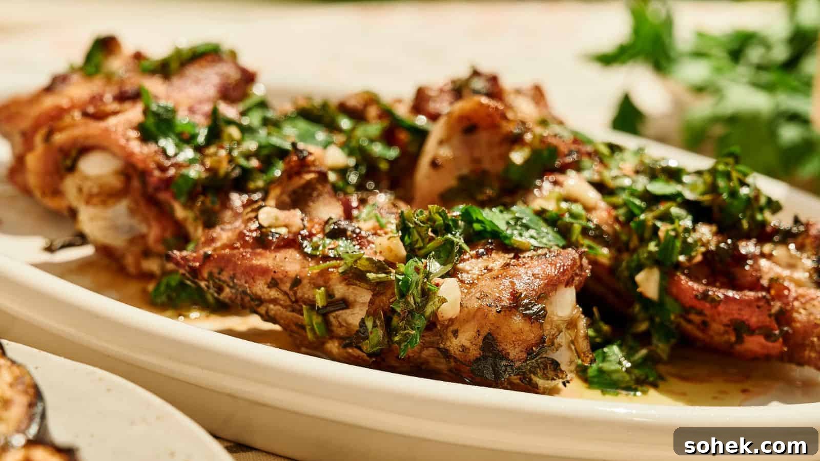 33 Quick Chicken Dinners for Busy Nights When You’re Tired but Hungry 28 Grilled meat ribs garnished with chopped herbs and garlic, served on a white platter with fresh parsley in the background.