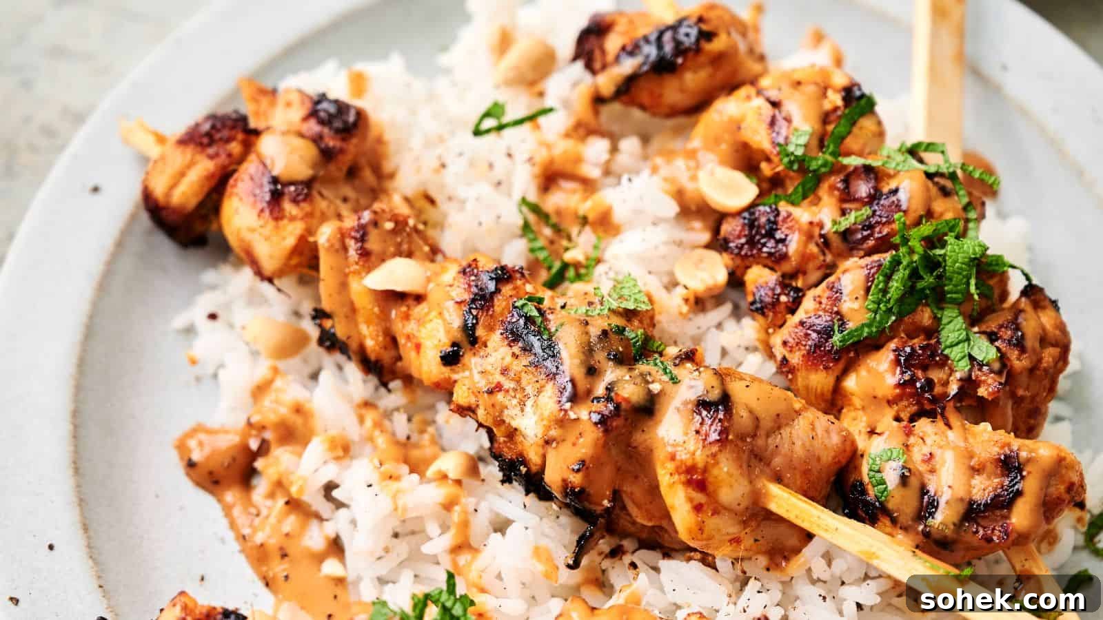 33 Quick Chicken Dinners for Busy Nights When You’re Tired but Hungry 31 Thai chicken skewers topped with a creamy sauce and garnished with chopped herbs and peanuts, served over a bed of white rice.