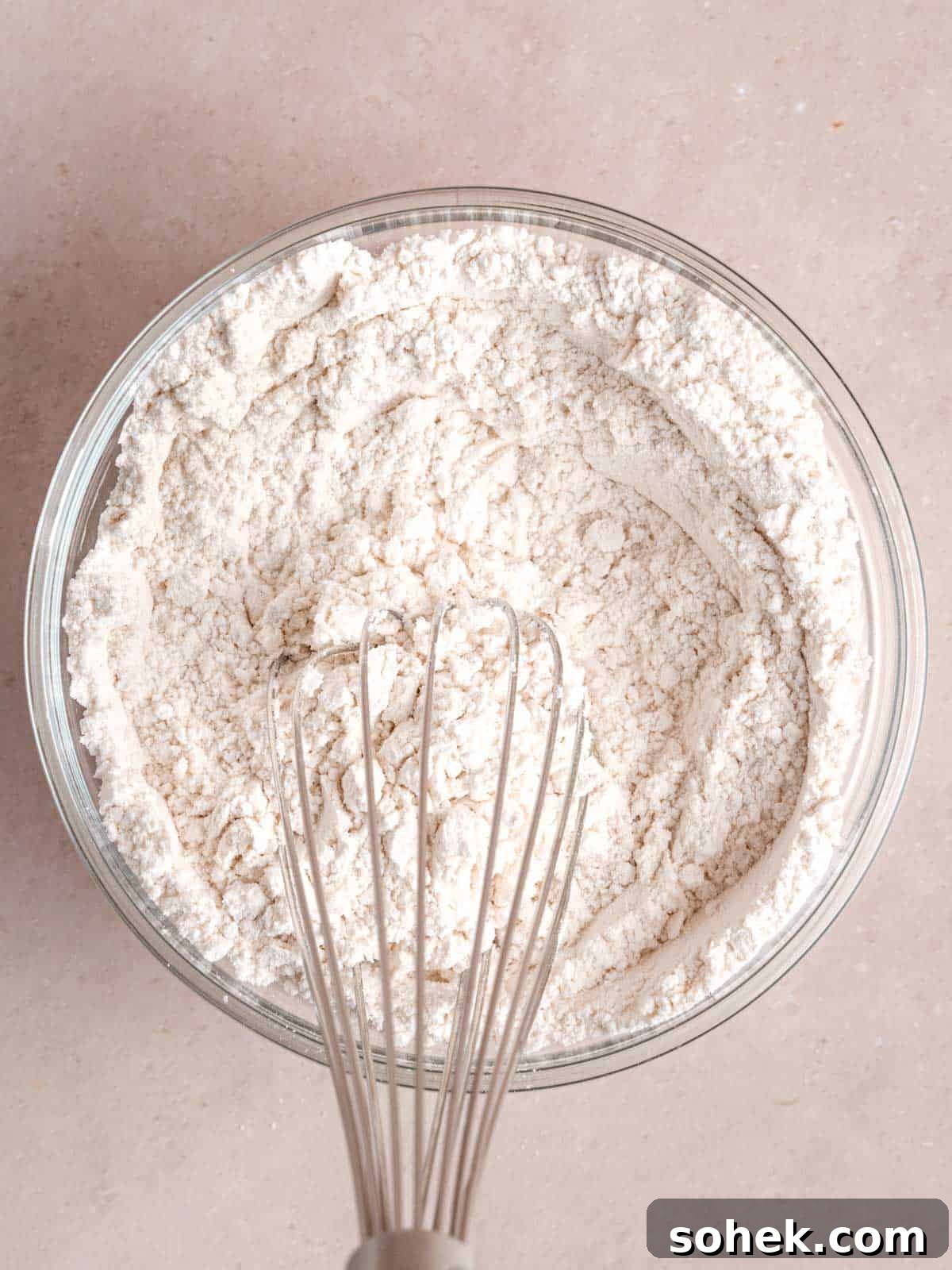 Whisking flour, baking powder, and salt in a bowl.