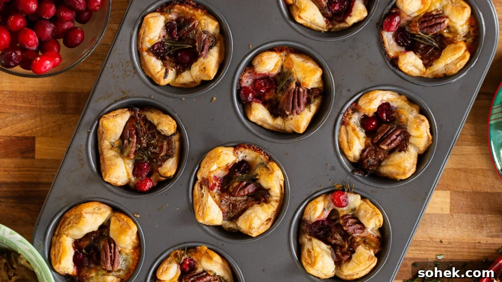 Brie and Caramelized Onion Puff Pastry Bites with Rosemary 3 Brie puff pastry bites in a muffin tray.