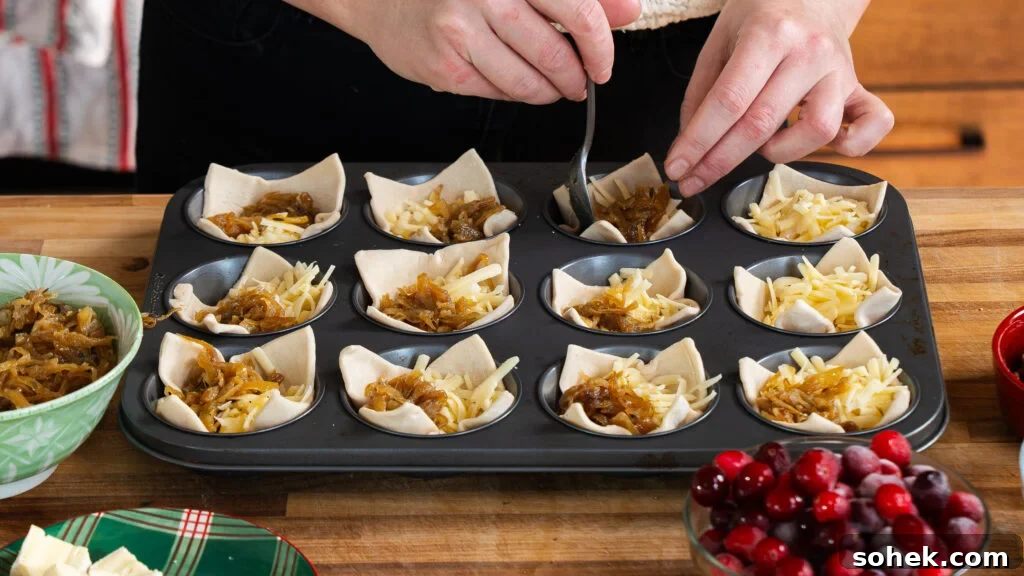 Brie and Caramelized Onion Puff Pastry Bites with Rosemary 7 Adding filling to puff pastry in muffin cups to make brie puff pastry bites.