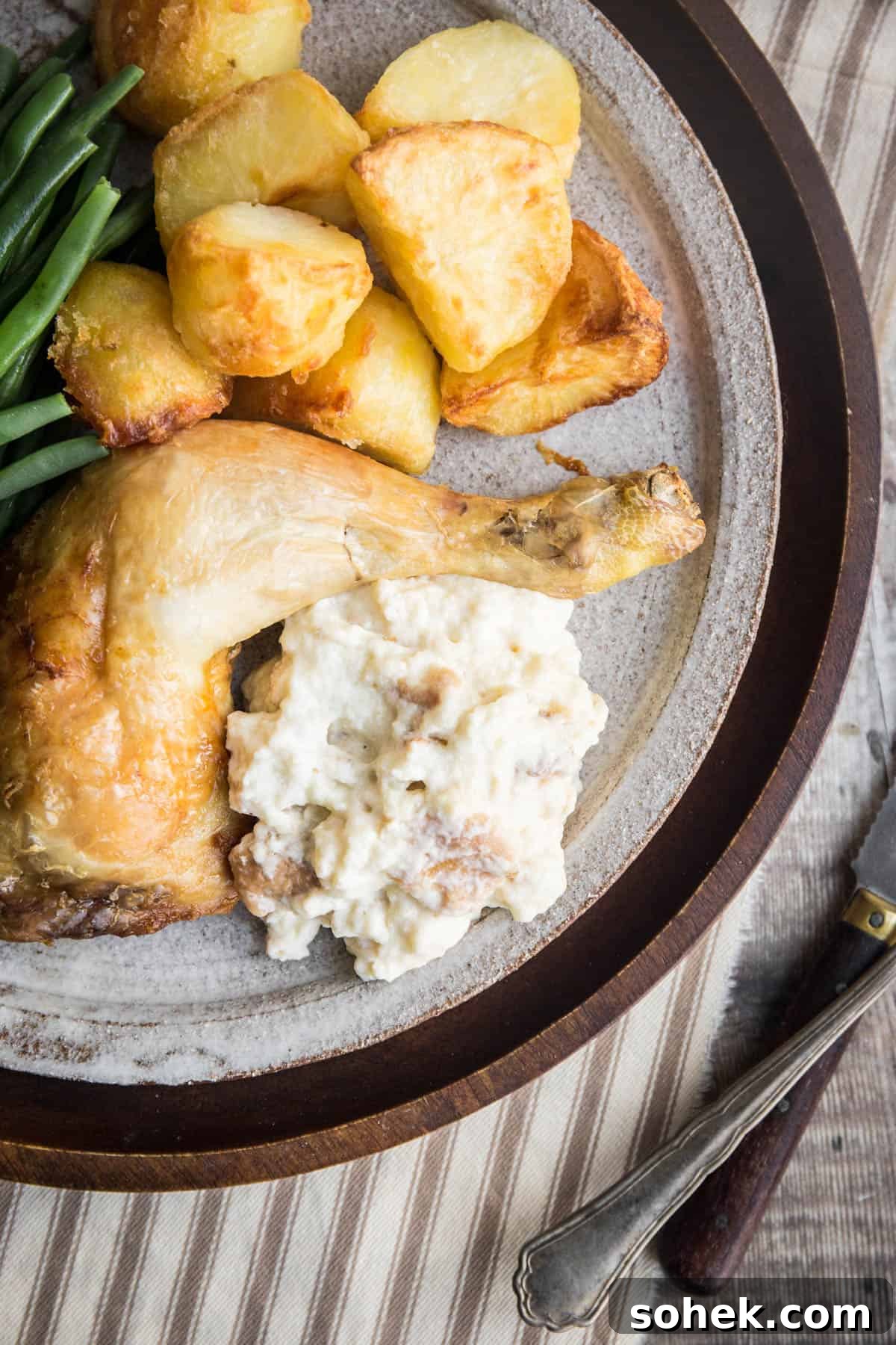 Classic Gluten-Free Bread Sauce Recipe for Roast Dinners 12 Plate of bread sauce accompanying roast chicken and vegetables. Next to bowl of bread sauce.