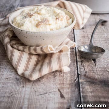 Classic Gluten-Free Bread Sauce Recipe for Roast Dinners 13 Bowl of bread sauce next to spoon.