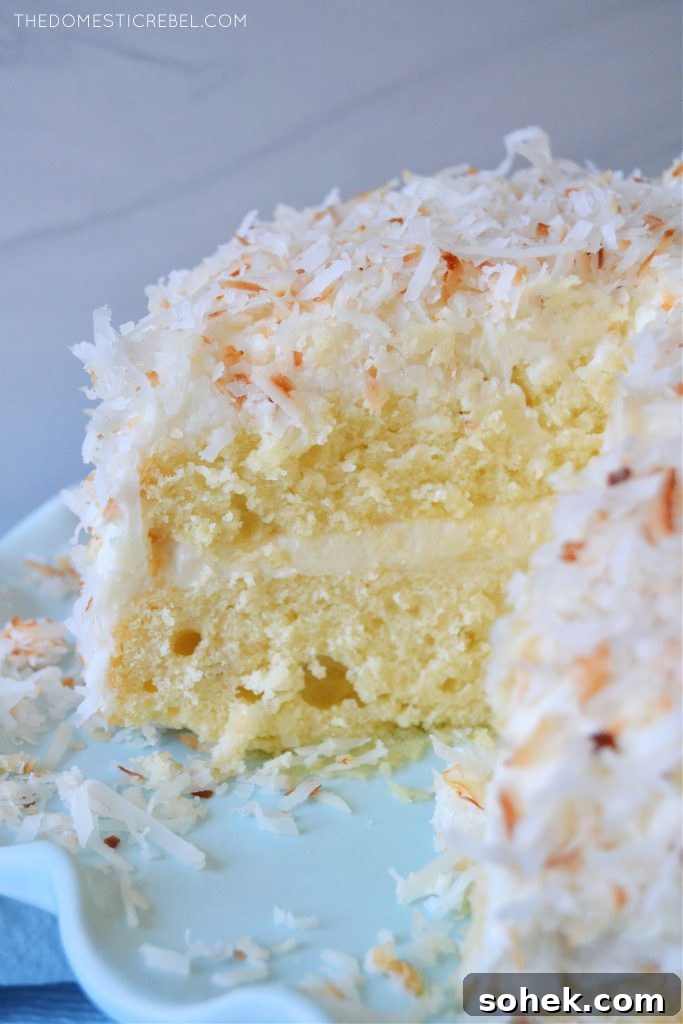coconut layer cake on a blue pedestal