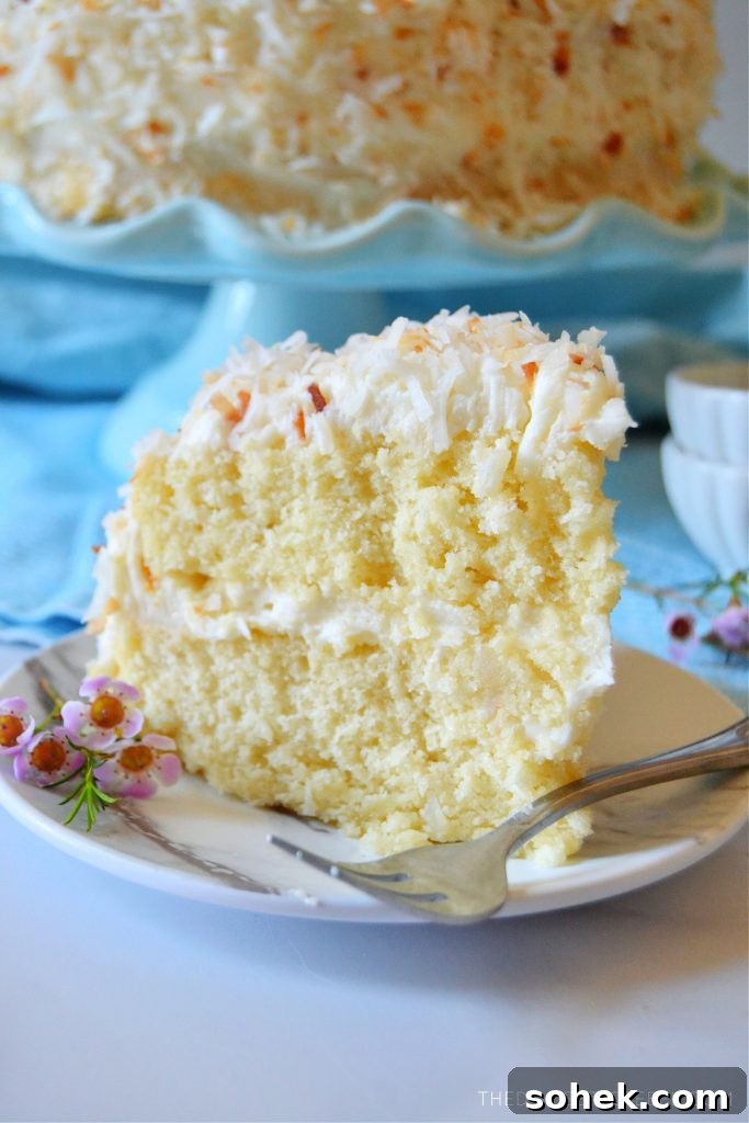 coconut layer cake with a fork on a plate