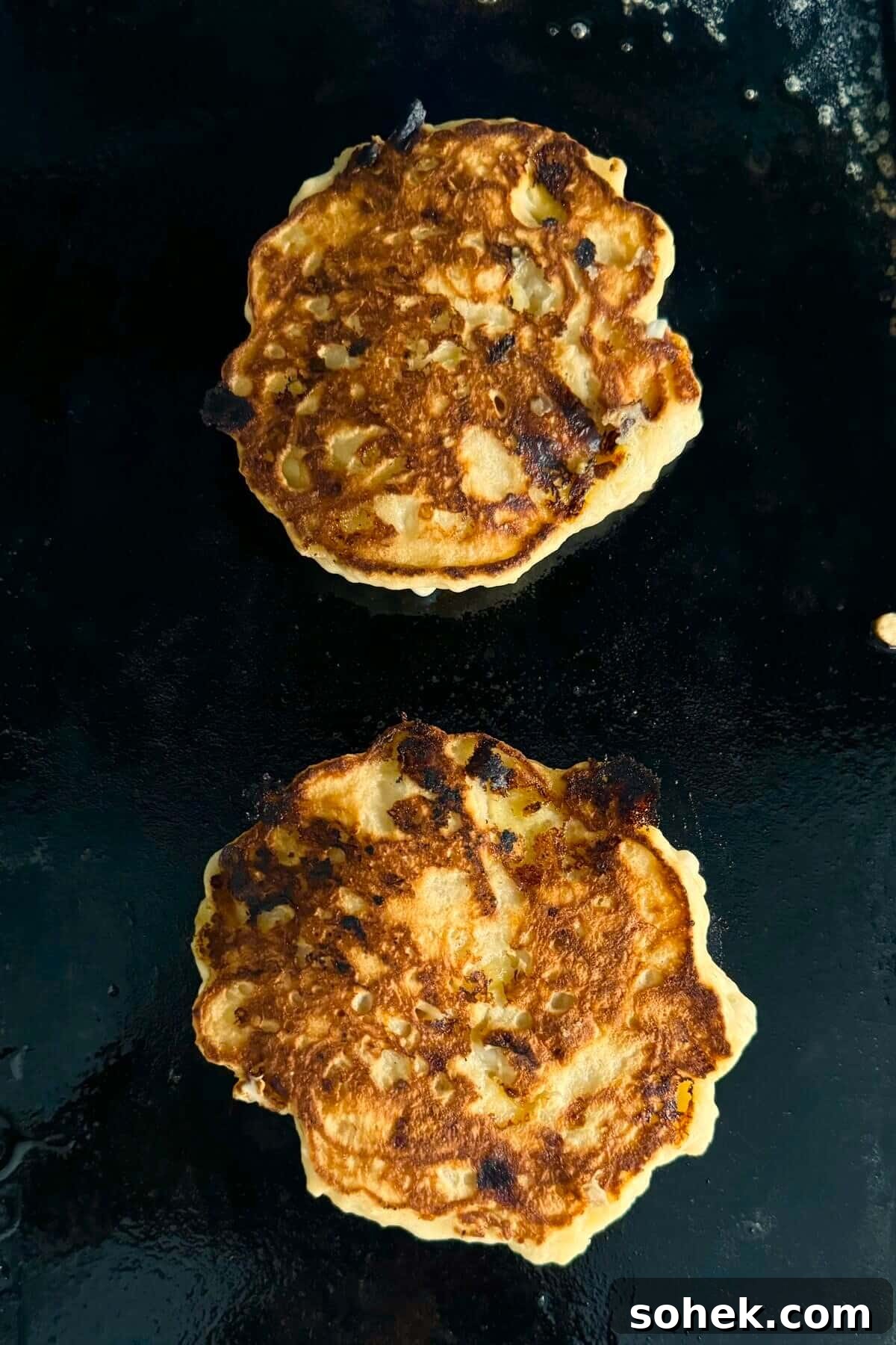 Fluffy Banana and Cottage Cheese Pancakes for Protein-Packed Breakfast 11 Cooked banana pancakes on a griddle.