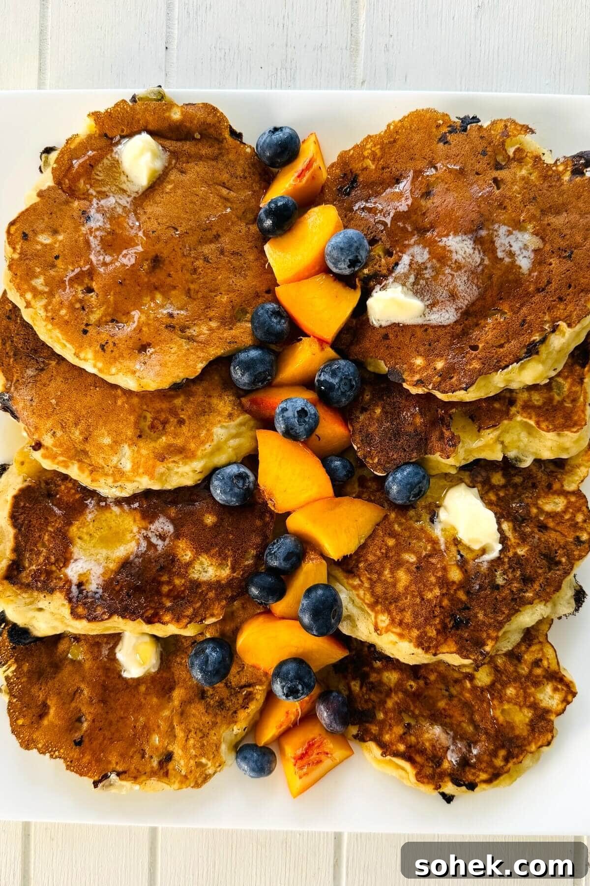 Fluffy Banana and Cottage Cheese Pancakes for Protein-Packed Breakfast 12 Cottage cheese protein pancakes with cut up fruit.