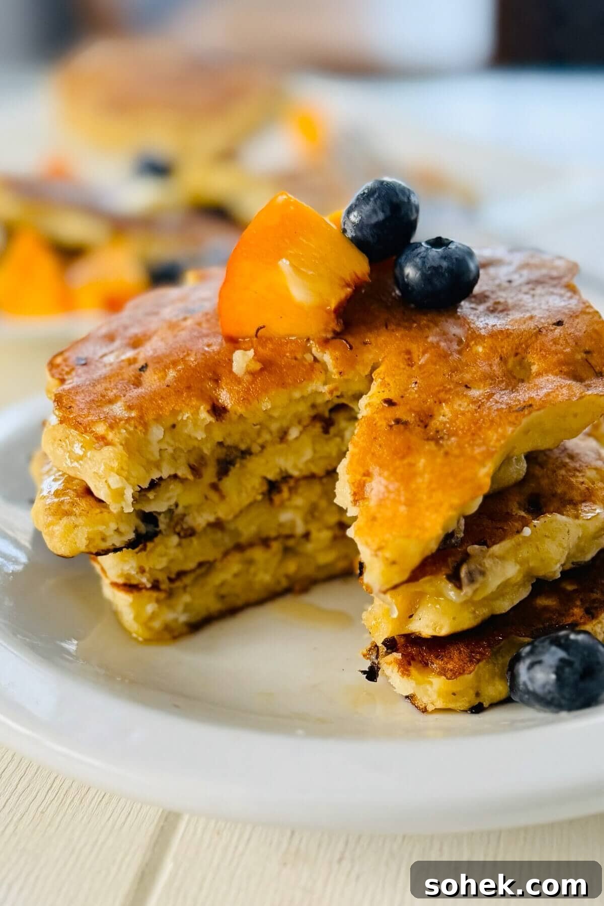 Fluffy Banana and Cottage Cheese Pancakes for Protein-Packed Breakfast 14 Stack of pancakes with bite cut out.