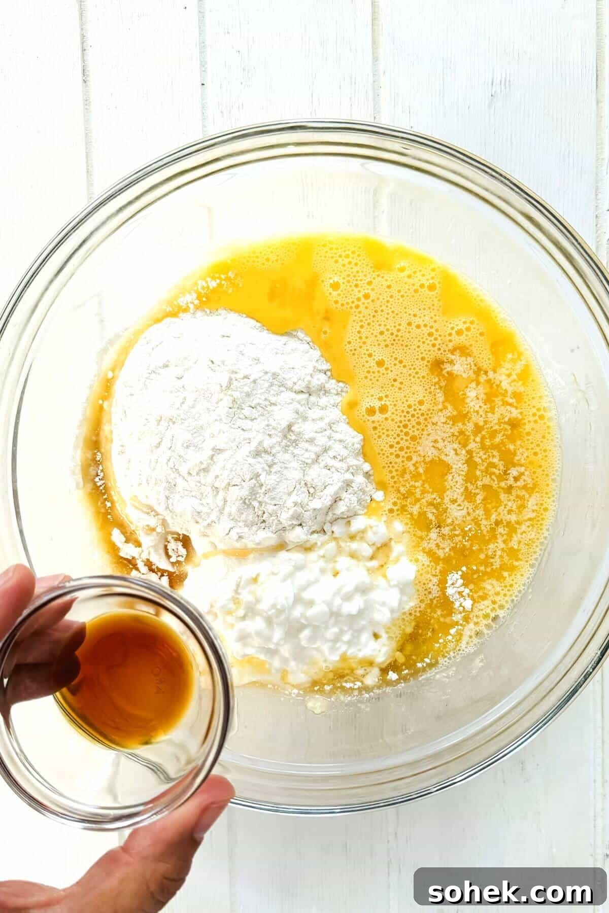 Fluffy Banana and Cottage Cheese Pancakes for Protein-Packed Breakfast 7 Vanilla being added to pancake ingredients.