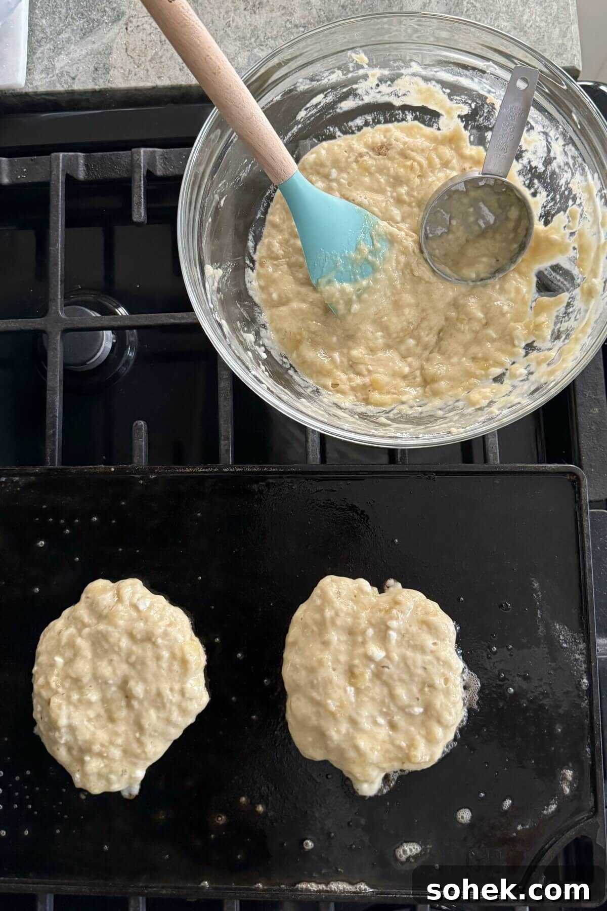 Fluffy Banana and Cottage Cheese Pancakes for Protein-Packed Breakfast 10 Pancake batter and 2 pancakes on a griddle.