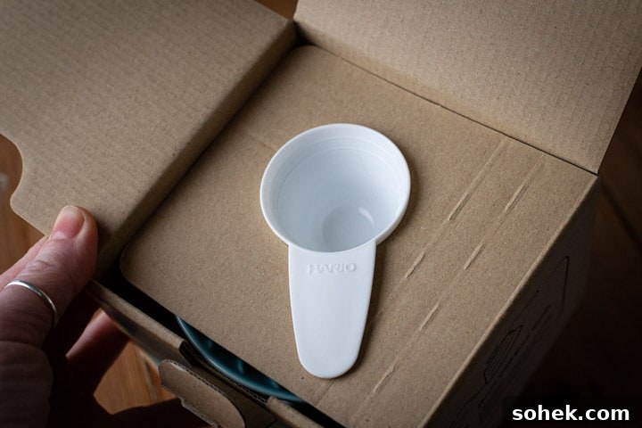 white coffee scoop within the cardboard packaging of the hario v60 box