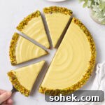 Pistachio tart seen from above with 4 slices cut off.
