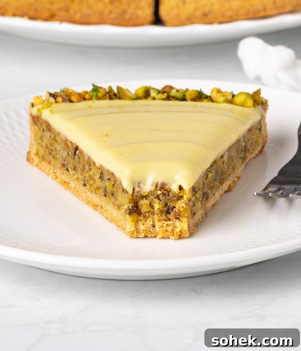 Close up on a slice of tart with a bite taken off.