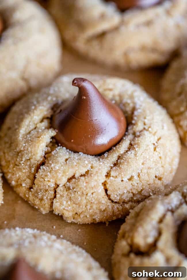 peanut butter blossoms with Hershey's kisses on parchment paper.