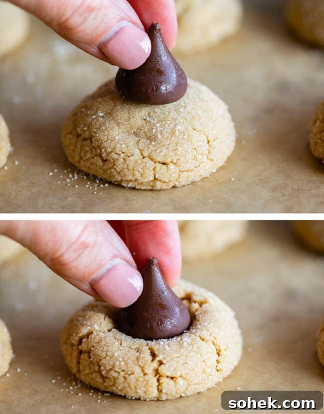 placing a Hershey's kiss on a baked peanut butter cookie.