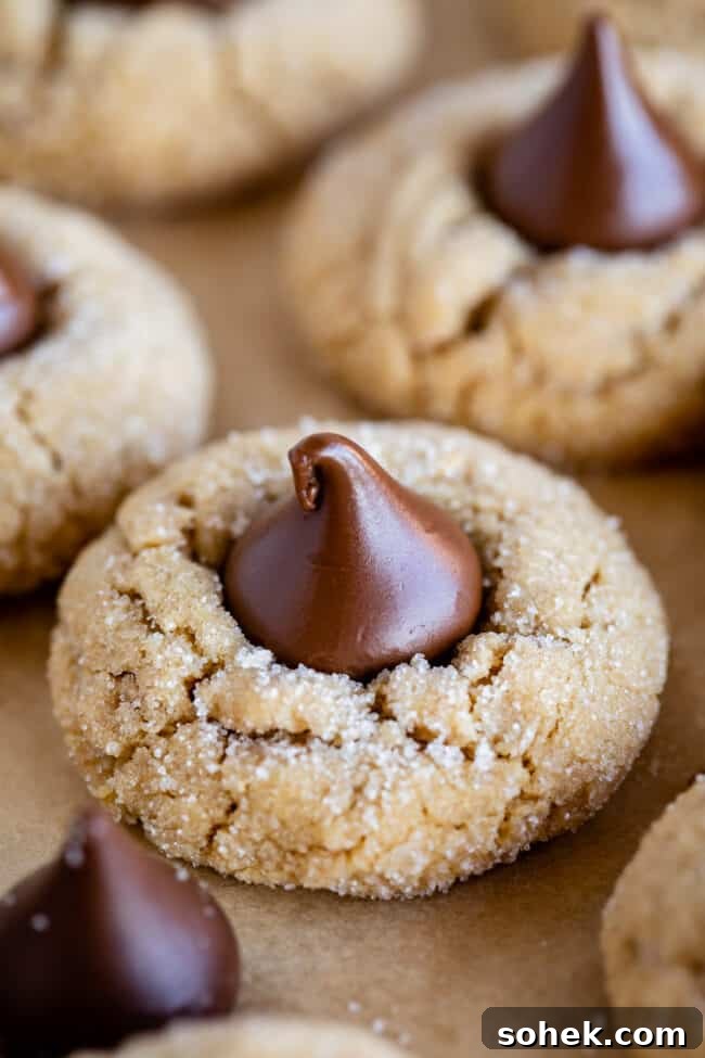 Hershey's peanut butter kiss cookies on parchment paper.