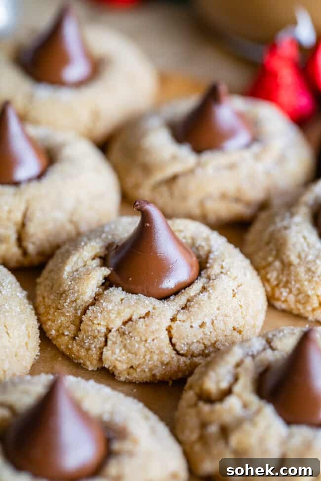 peanut butter blossom cookies lined up on parchment paper.