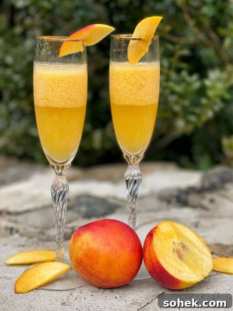Stunning Italian Dinner Party Menu Ideas to Impress Your Guests 5 Two glasses of peach Bellinis sitting on a stone wall next to fresh peaches.
