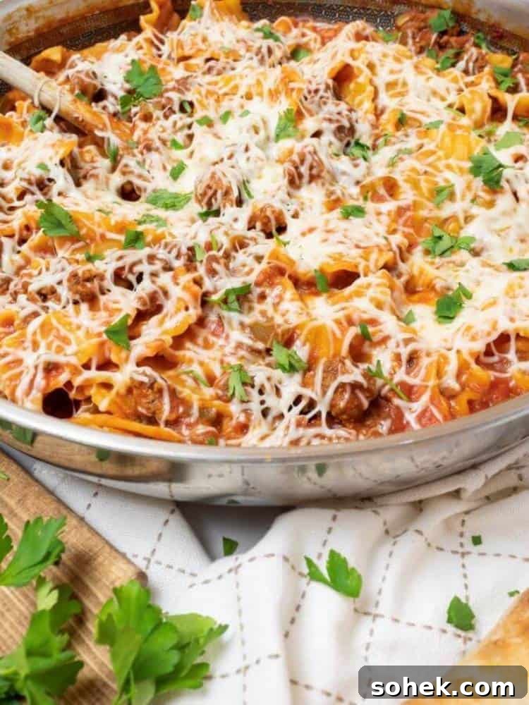 Stunning Italian Dinner Party Menu Ideas to Impress Your Guests 6 Stainless steel skillet filled with Skillet Lasagna on a serving board.