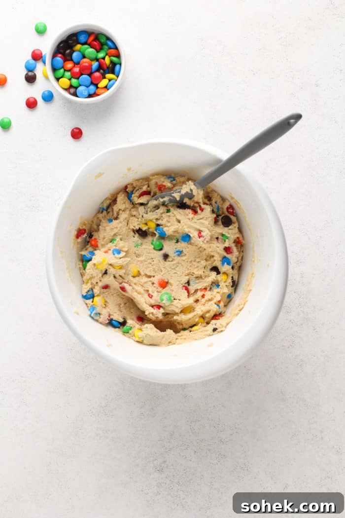 Chewy M&M Cookies Recipe for Perfect Chocolate Crumble 6 M&M cookie dough in a white mixing bowl.