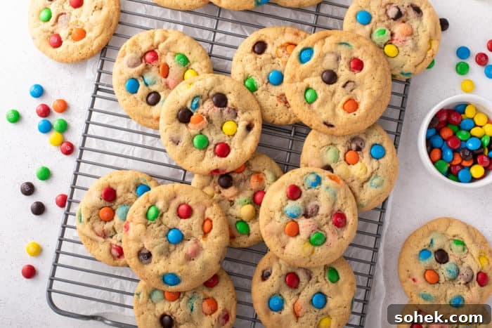 Chewy M&M Cookies Recipe for Perfect Chocolate Crumble 9 M&M cookies arranged on a wire cooling rack to cool.