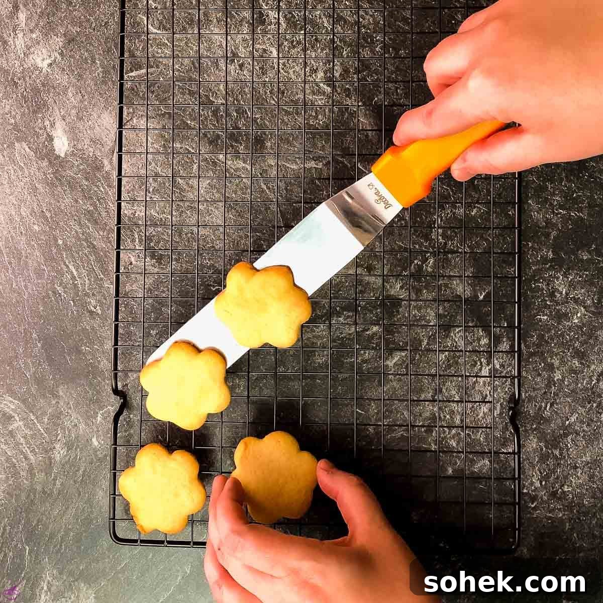 No-Chill Cut-Out Sugar Cookies Recipe — Soft, Ready-to-Roll 7 Flower shape sugar cookies on cooling rack.