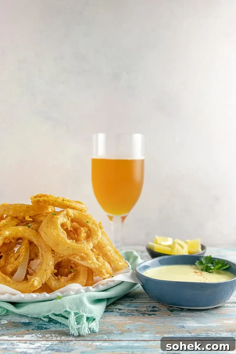 Old Bay Onion Rings with Tangy Lemon Dipping Sauce 3 Beer Battered Old Bay Onion Rings with Creamy Lemon Dipping Sauce - An appetizer or side dish that's boardwalk ready, no matter where you are!