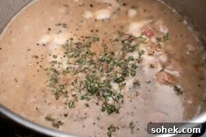 Greggs-Style Steak Bake Recipe: How to Make It at Home 10 Fresh thyme added to the steak bake filling cooking in a large cooking pot
