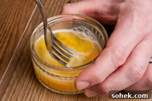 Greggs-Style Steak Bake Recipe: How to Make It at Home 16 Whisking an egg together in a glass dish using a fork