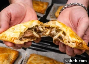 Greggs-Style Steak Bake Recipe: How to Make It at Home 20 Pulling apart a Steak Bake with cheese