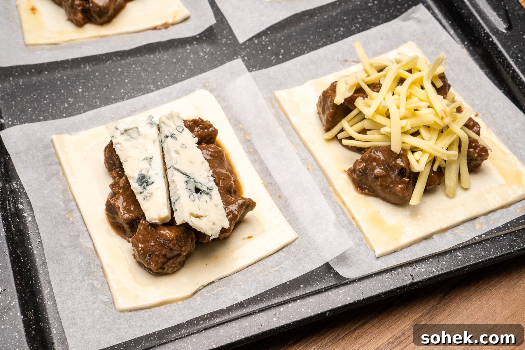 Greggs-Style Steak Bake Recipe: How to Make It at Home 24 Steak filling on a sheet of puff pastry with cheese on top