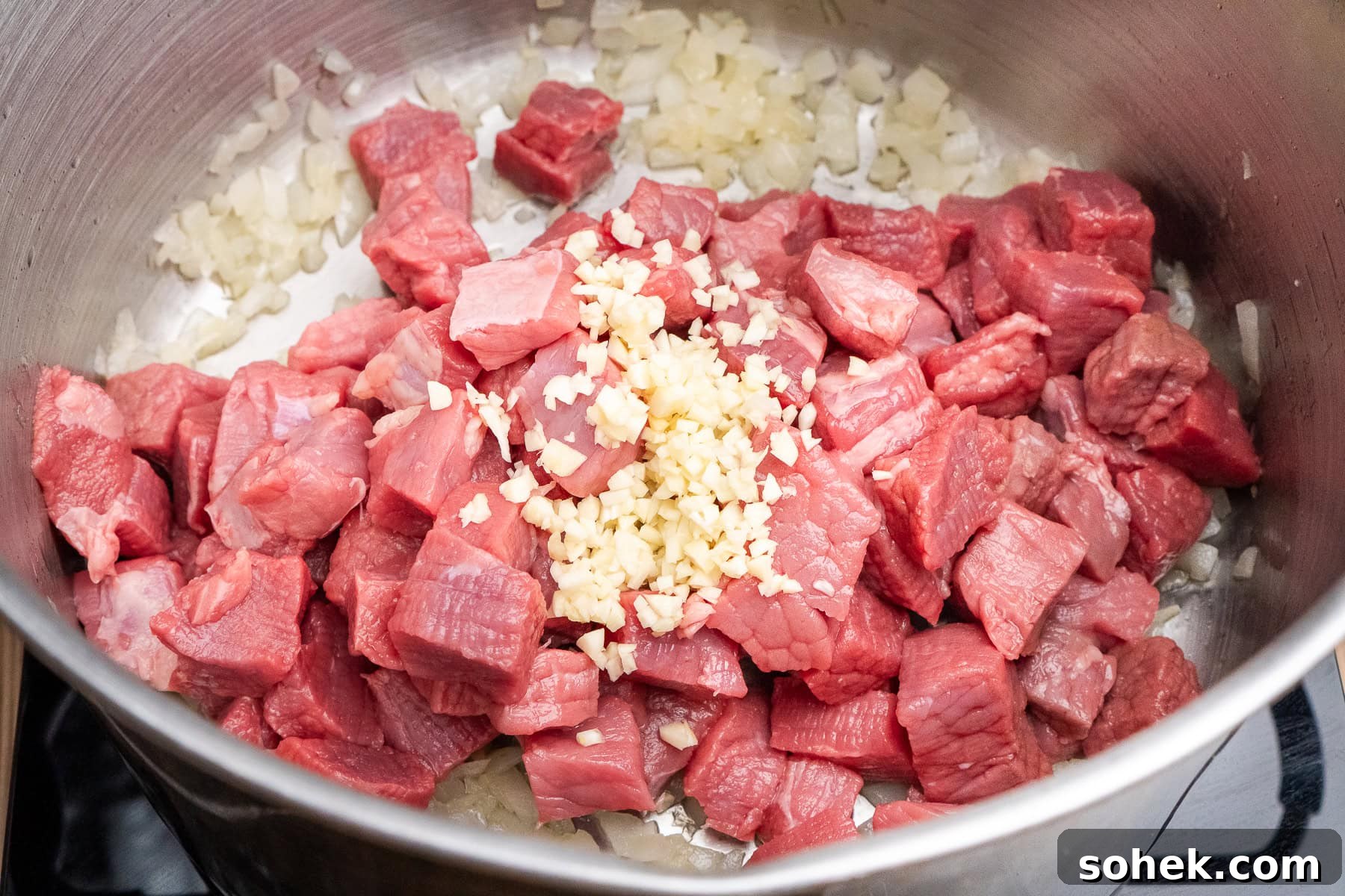 Greggs-Style Steak Bake Recipe: How to Make It at Home 27 Chopped stewing steak, chopped garlic added to the fried chopped onion in a cooking pot