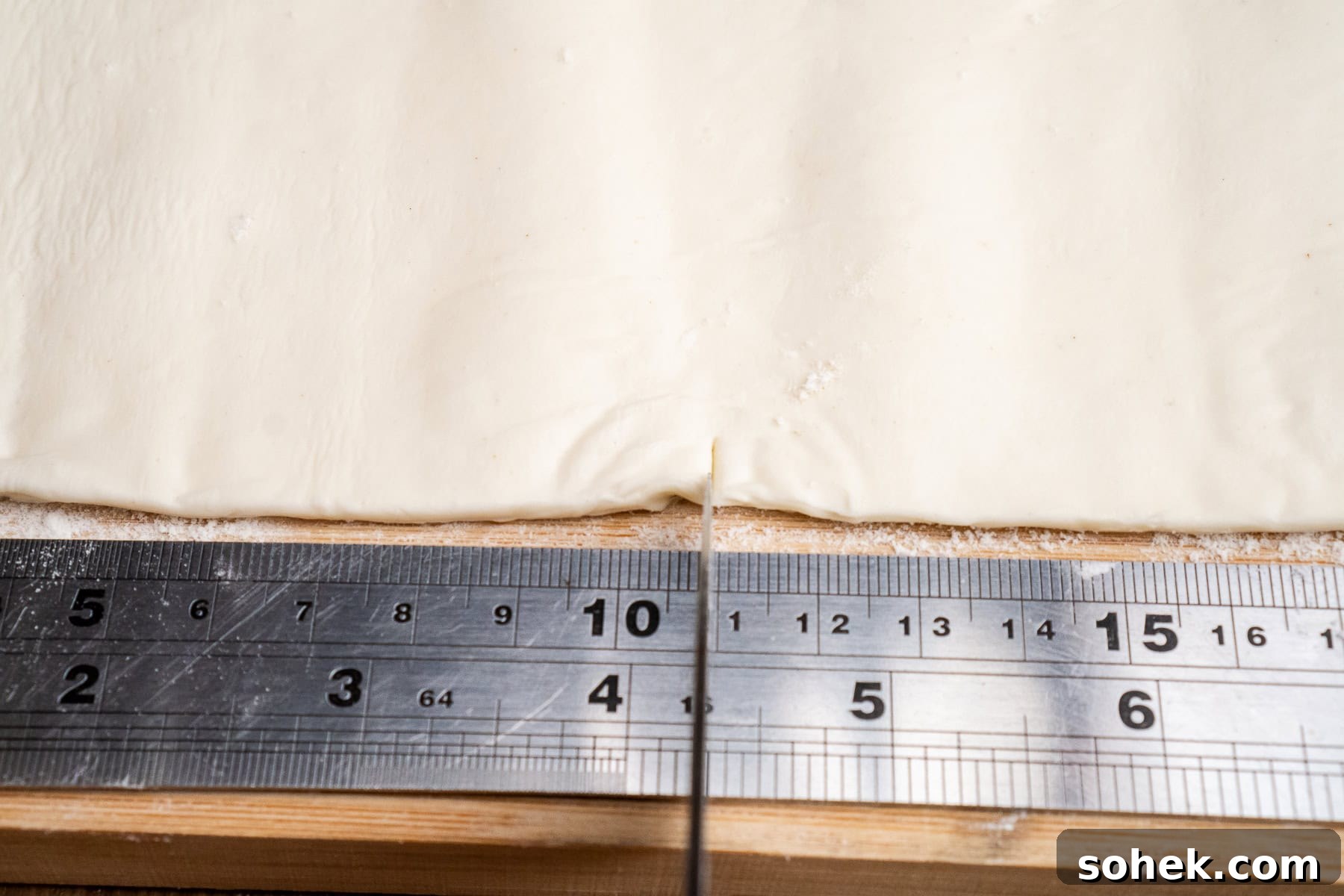 Greggs-Style Steak Bake Recipe: How to Make It at Home 31 Cutting a square bit of puff pastry using a metal ruler