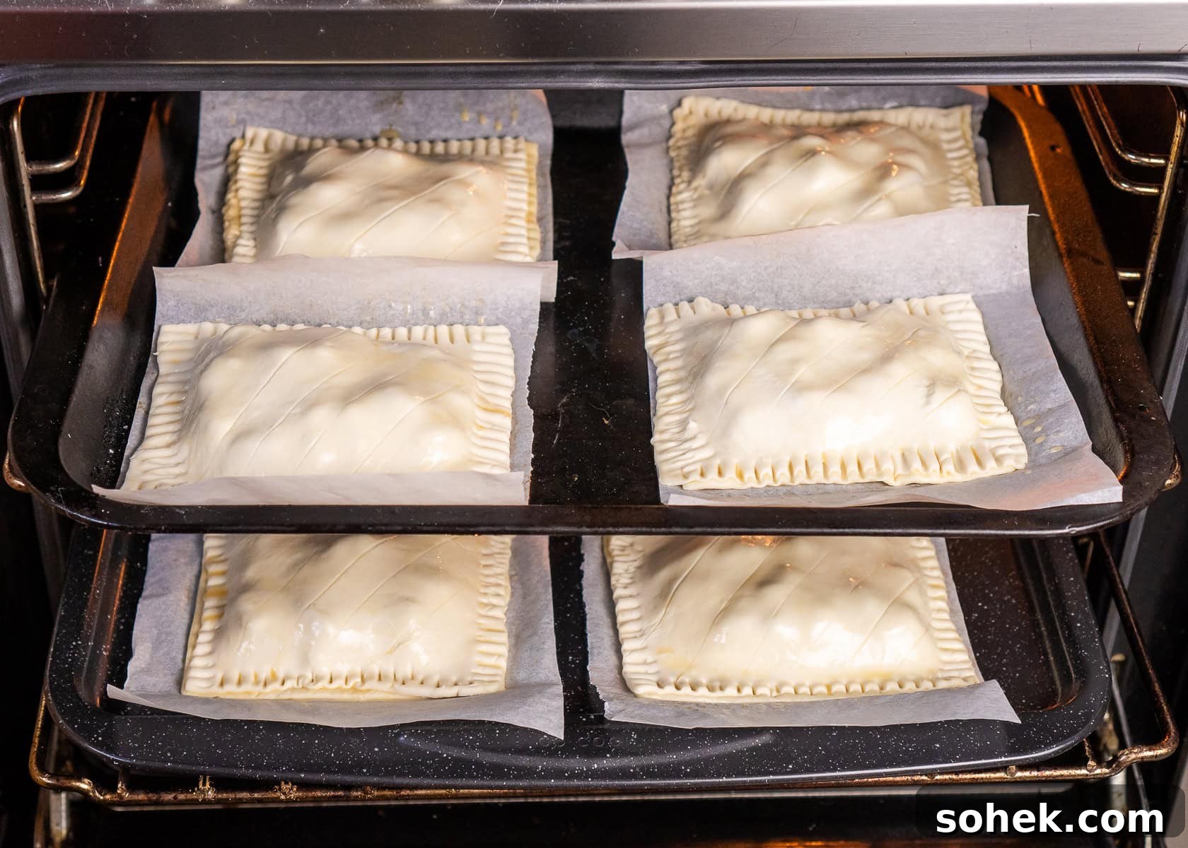 Greggs-Style Steak Bake Recipe: How to Make It at Home 39 Eight egg washed steak bakes on baking trays going into the oven