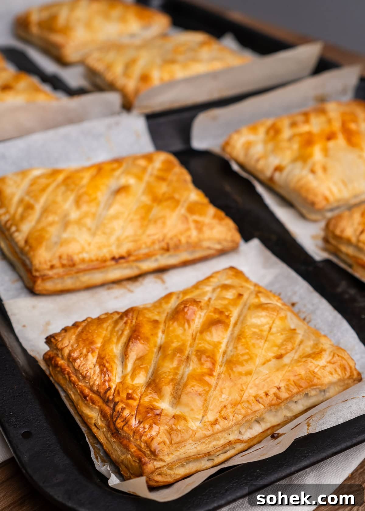Greggs-Style Steak Bake Recipe: How to Make It at Home 41 Steak bakes on parchment paper and baking trays