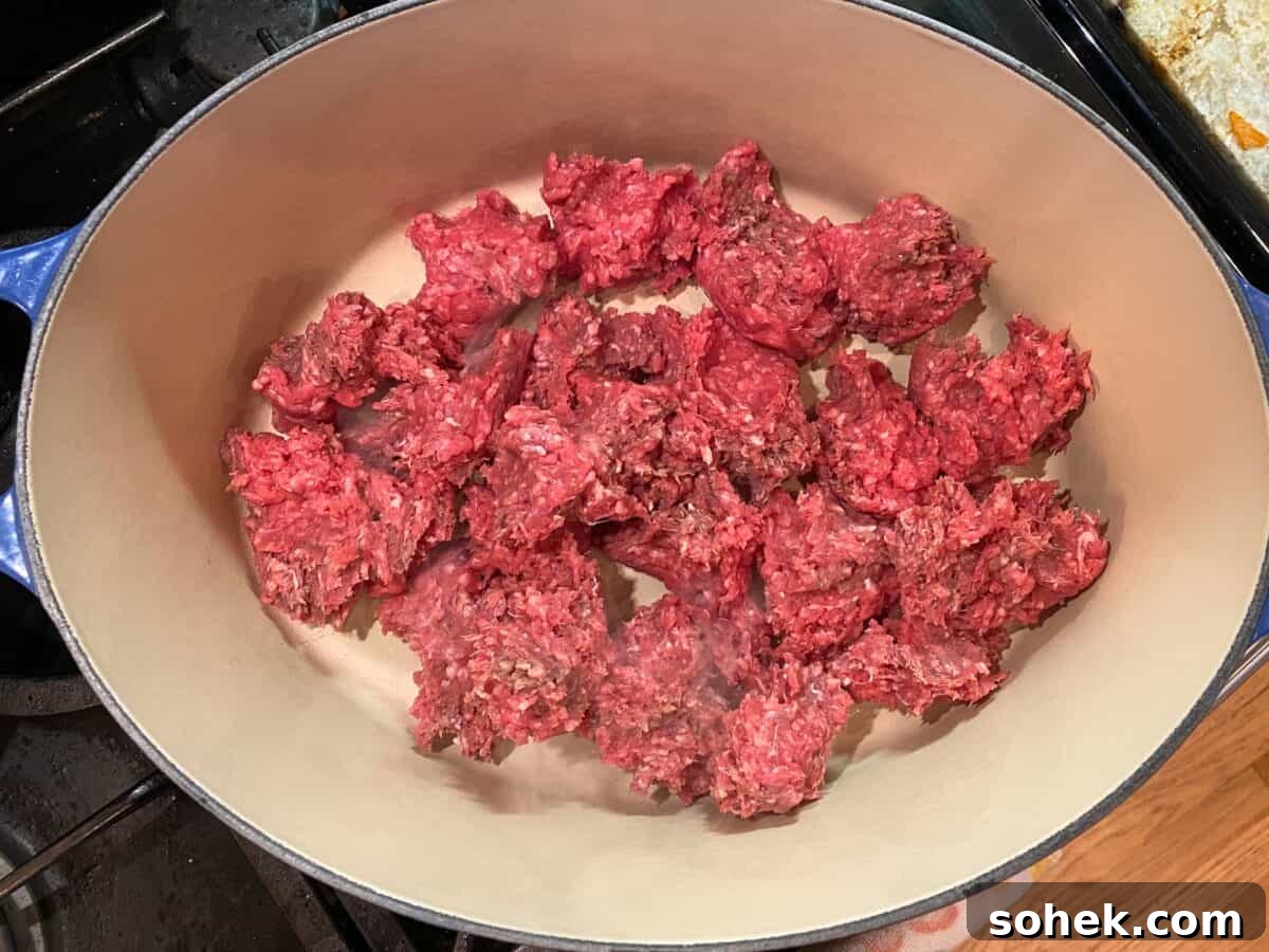 Classic Idaho Chili Recipe: Hearty Potato and Beef Chili 4 Uncooked ground beef in a large stockpot on the stove.