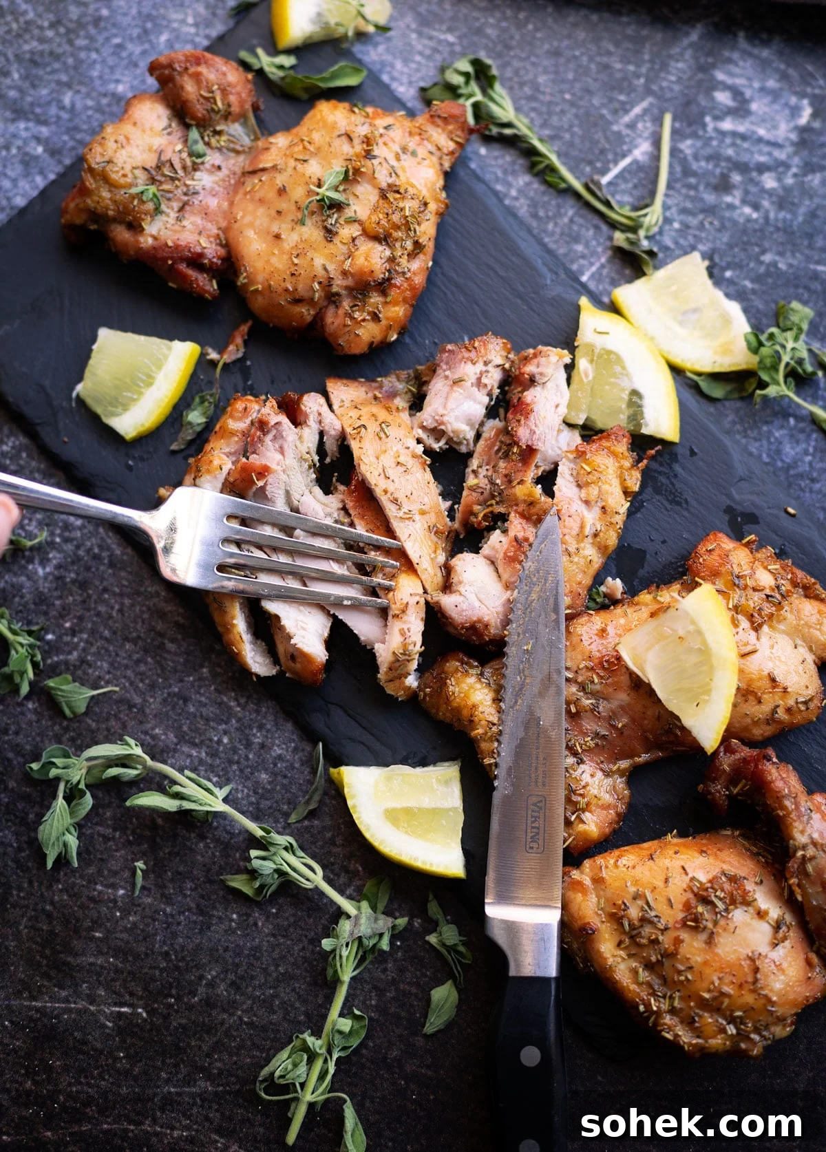 Juicy Smoked Chicken Thighs with Crispy Skin Recipe 11 Sliced smoked chicken thighs on a cutting board.