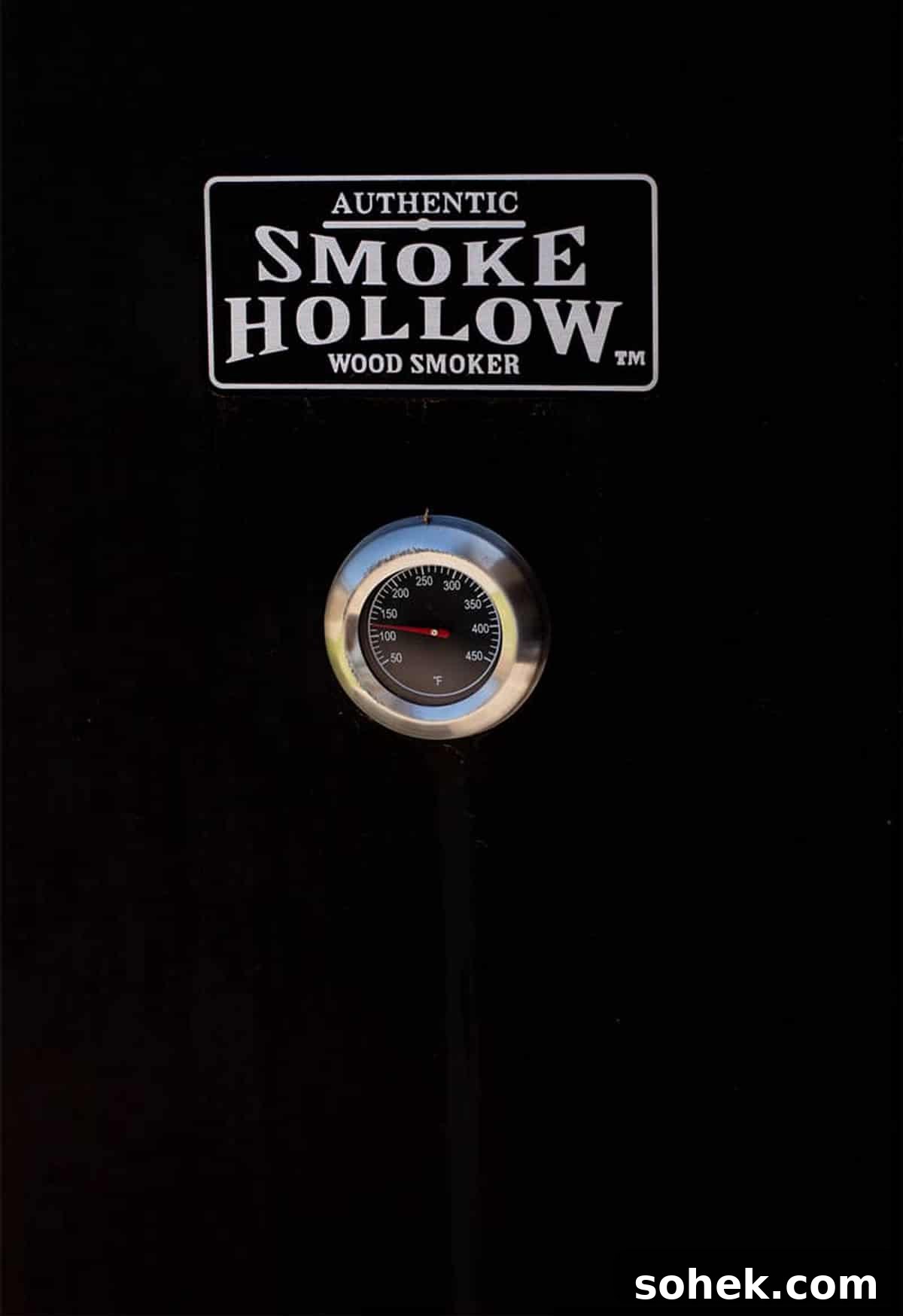 Juicy Smoked Chicken Thighs with Crispy Skin Recipe 5 Picture of the door of a black Smoked Hollow Wood Smoker.